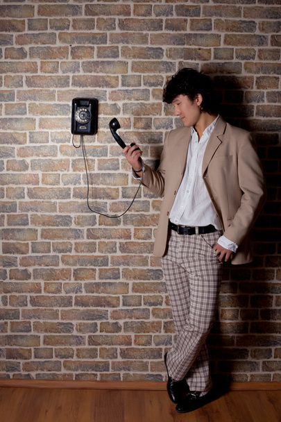 Young asian man with old telephone - Fotoğraf, Görsel