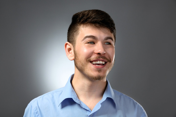 Portrait of smiling man on gray background - Φωτογραφία, εικόνα