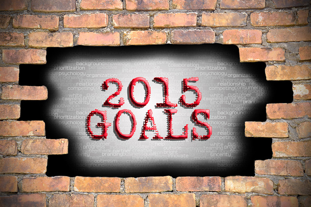 Hole at the brick wall with 2015 goals caption inside - Photo, Image