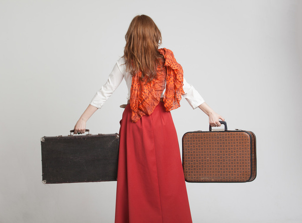 Woman in vintage red skirt with suitcases - Φωτογραφία, εικόνα