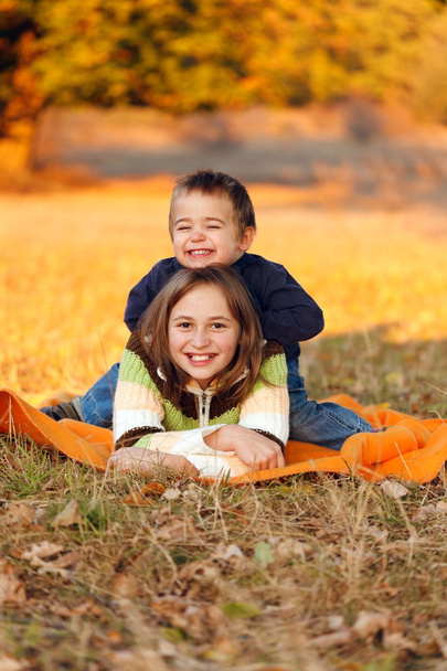 Kids playing outdoors in autumn - Photo, image