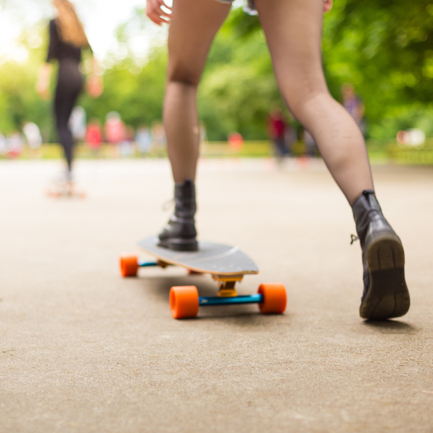 Teenage girl urban long board riding. - Valokuva, kuva