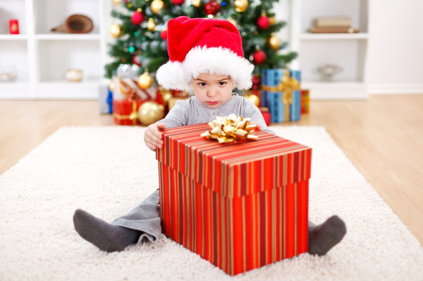 Little boy sitting behind big present - Фото, изображение