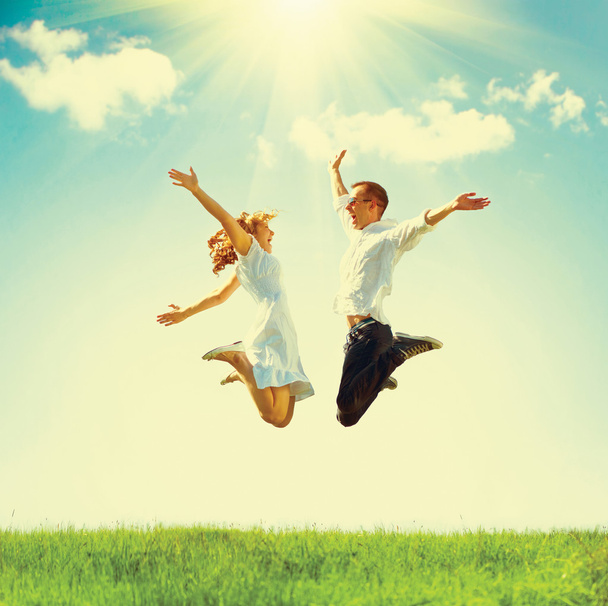 Jumping family on green field - Фото, изображение