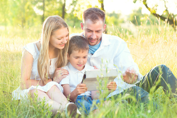 family with kid using tablet pc - Fotografie, Obrázek