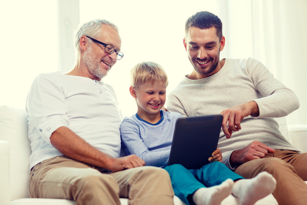 smiling family with tablet pc at home - Foto, Bild