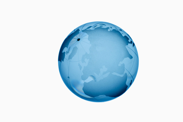 Blue glass globe against white background,close up - Photo, Image