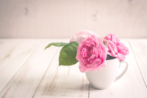 Pink tea roses on a white wooden background - Photo, Image