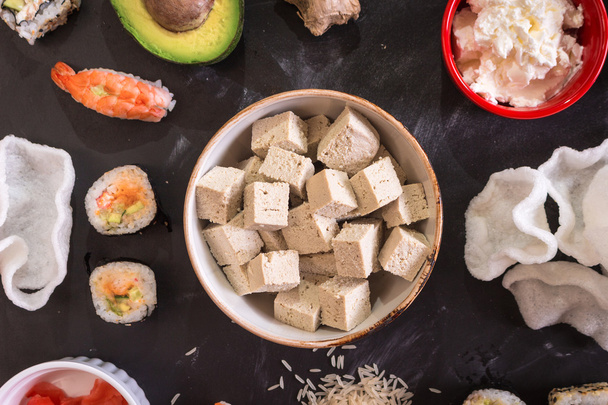 Сыр тофу и суши на тёмном фоне
 - Фото, изображение