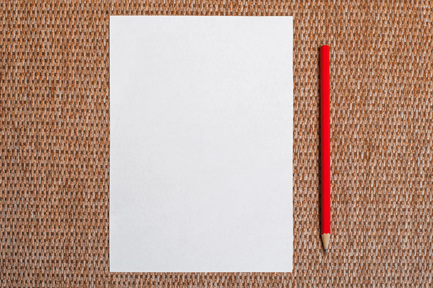 White paper and red pencil on background - Fotó, kép