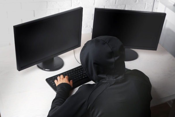 Hacker with computers in room - Foto, Imagen