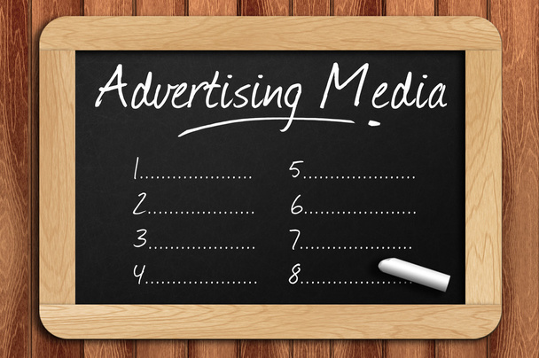 Chalkboard on the wooden table written advertising media list - Photo, Image