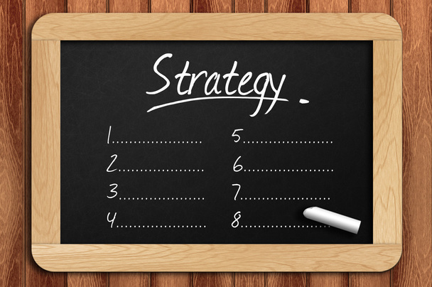 Chalkboard on the wooden table written strategy list - Photo, Image