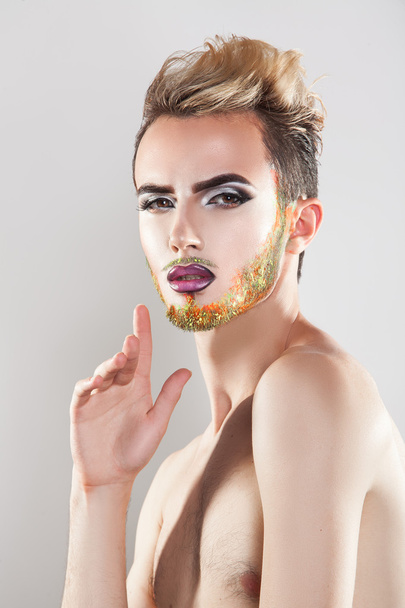 Pretty sensual man with makeup and multicolor beard looking at c - Φωτογραφία, εικόνα