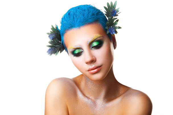 Shy young girl with flowers in hair and multicolor makeup - Foto, Imagem