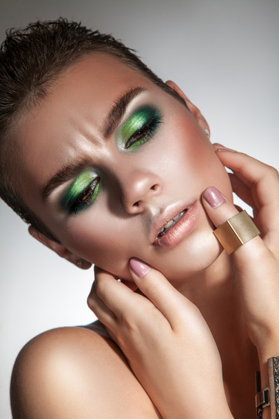 serious fashion model with beautiful green makeup looking down - Zdjęcie, obraz