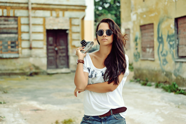 Beautiful young woman posing with old fashion camera - Photo, Image