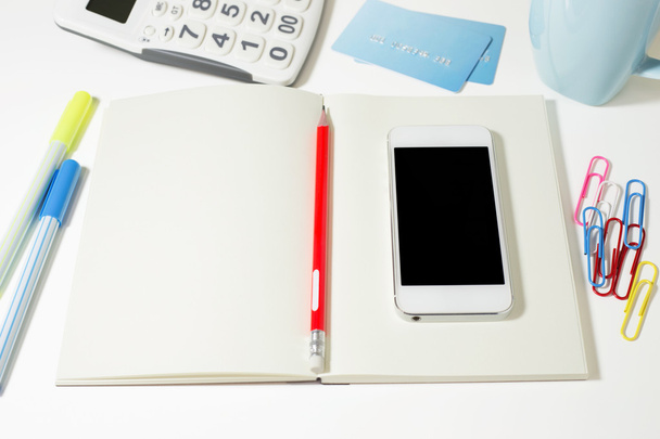 Work table with blank notebook and phone - Valokuva, kuva