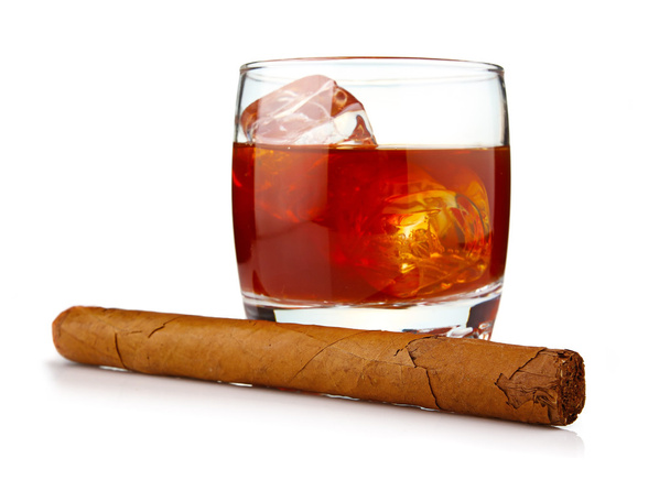 Glass of whiskey with ice cubes and havana cigar isolated - Photo, Image