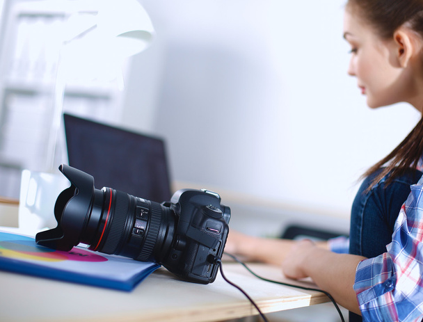 Female photographer sitting on the desk with laptop - Foto, Imagen