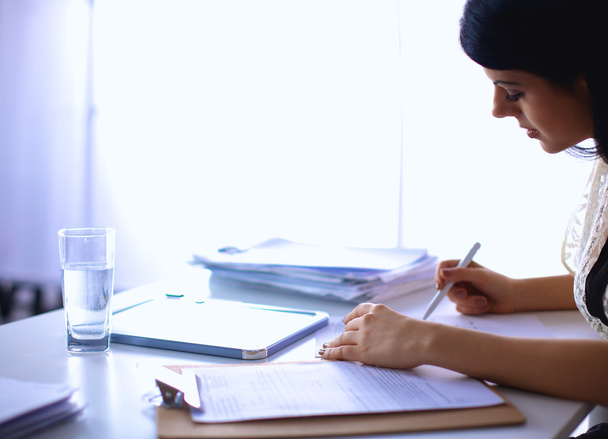 Woman with documents sitting on the desk - Photo, Image