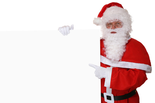Santa Claus pointing with finger on Christmas at empty banner - Foto, afbeelding