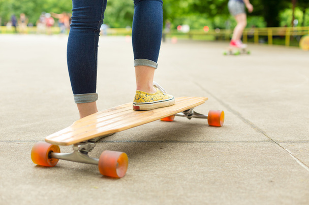 Teenage girl practicing riding long board. - Photo, Image