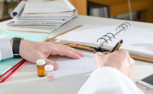 Doctor writing prescription - Фото, изображение