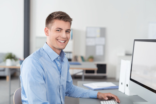 Handsome Young Businessman Sitting at Office Desk - Foto, immagini
