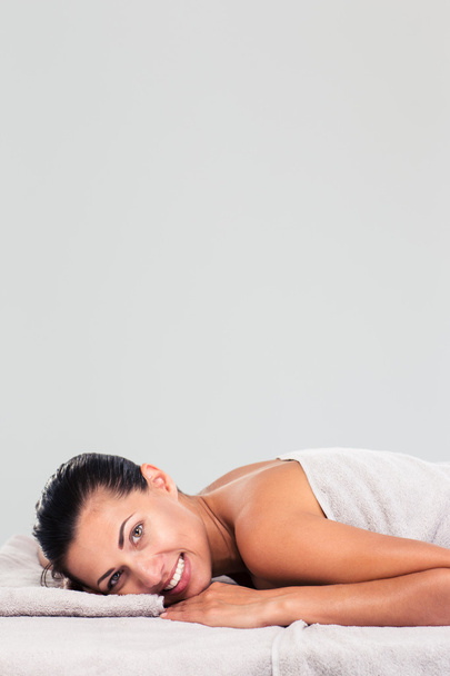 Charming woman lying on massage lounger  - Fotografie, Obrázek