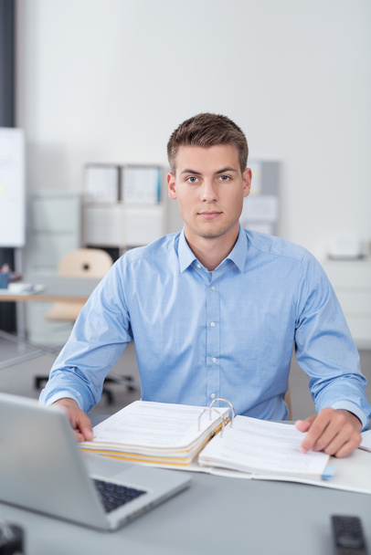 Businessman at his Desk with Reports in a Binder - Φωτογραφία, εικόνα