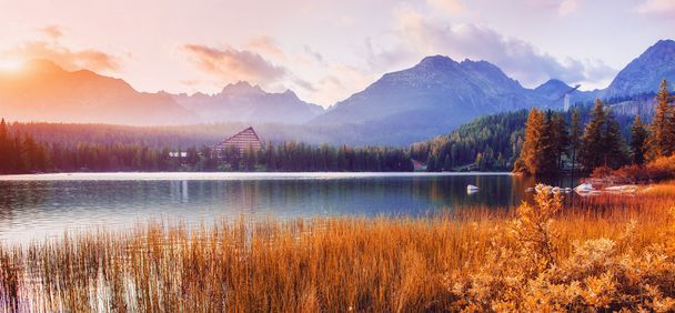The sunrise over a lake in the park High Tatras. Shtrbske Pleso - Zdjęcie, obraz
