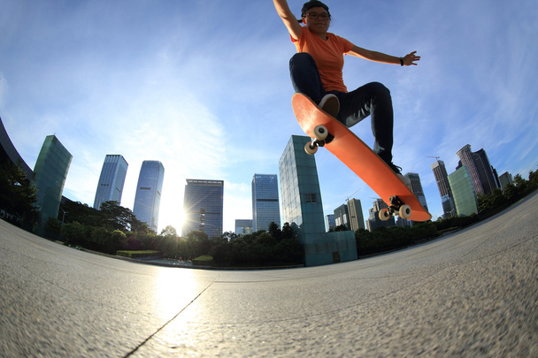 Skateboarder legs skateboarding at city - Фото, изображение