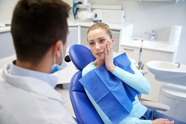 male dentist with woman patient at clinic - Foto, Bild