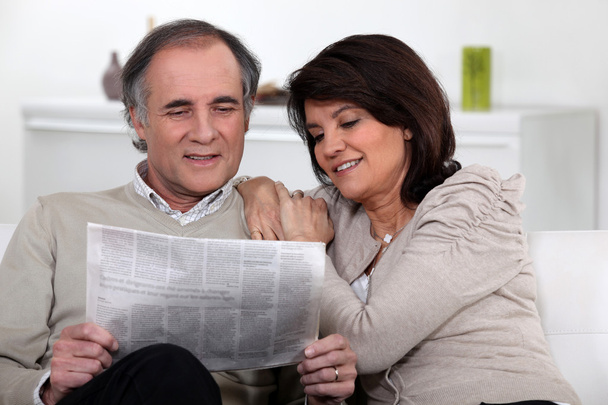 Couple reading the newspaper together - Фото, зображення