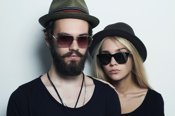 fashion beautiful couple in hat together. Hipster boy and girl in sunglasses - Photo, Image