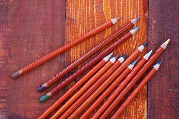 Pencils on wooden background - Фото, зображення