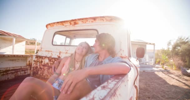 Teen couple sitting in a vintage truck - Felvétel, videó