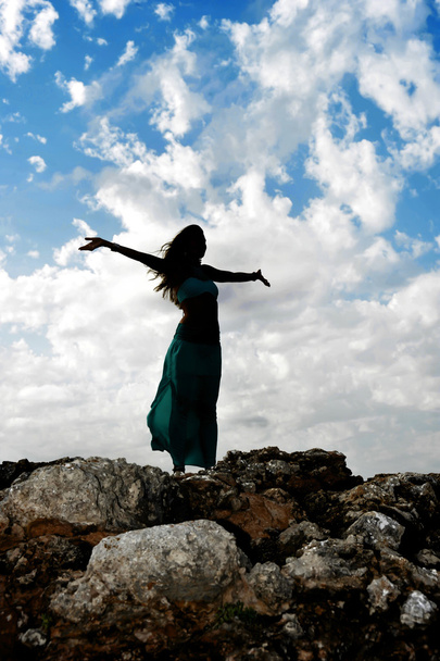 Silhouette of young attractive woman with opened arms outdoors i - 写真・画像