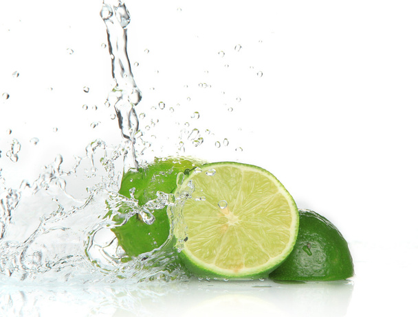 Green limes with splashing water - Fotó, kép