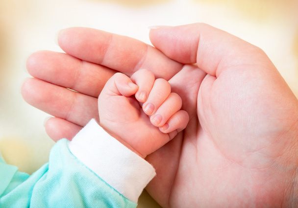 Baby hand in mother's palm - Photo, Image