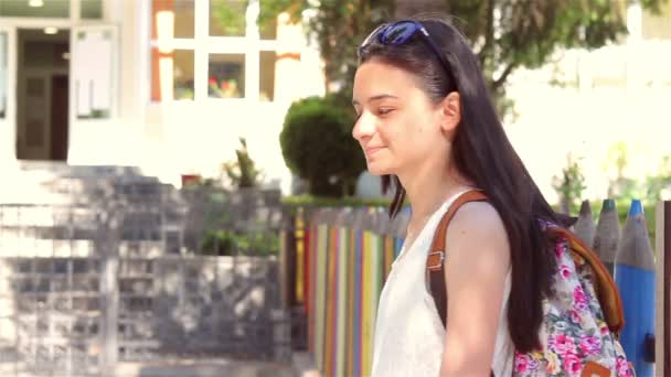 Mladá dívka s batohem jede zpátky do školy - Záběry, video