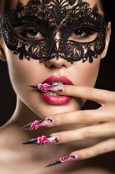 Beautiful girl in mask with long nails and sensual lips. Beauty face. - Zdjęcie, obraz