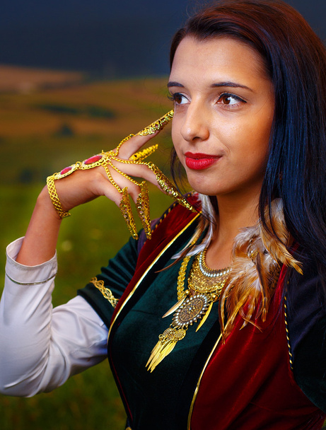 Young woman with ornamental dress and hand jewel. Natural background. - Fotoğraf, Görsel