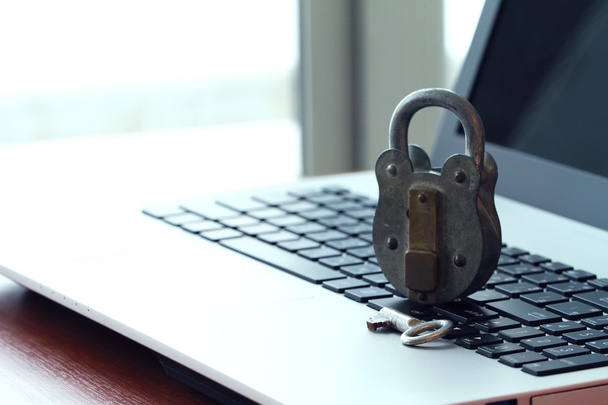 Internet security concept-old padlock and key on laptop computer - Photo, Image