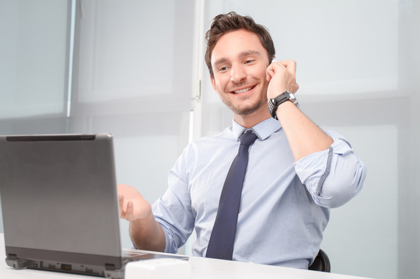 Call center operator holding mobile phone  - Photo, image