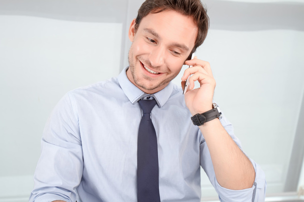 Call center operator talking on mobile phone  - Фото, изображение