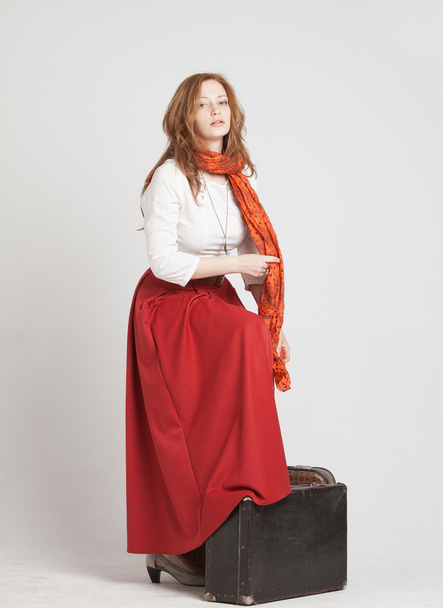 Woman in vintage red skirt with suitcases - Photo, Image