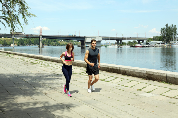 Young people jogging near river - Foto, immagini