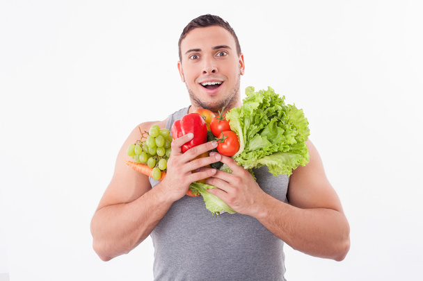 Attractive young guy is fond of fruits and vegetables - Fotó, kép
